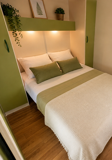 Zimmer mit 1 Doppelbett im Chalet „Morea“, das auf dem Campingplatz Saint-Point Lamartine in Burgund vermietet wird